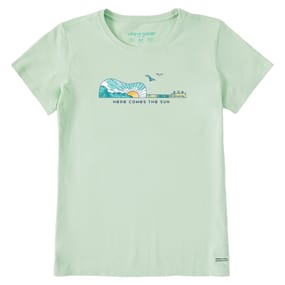 Light green T-shirt with a guitar-shaped graphic featuring a sun, sky, and birds. Below the graphic, \“Here Comes the Sun\“ is printed. Made by Life is Good.