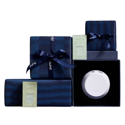 A set of navy gift boxes with blue ribbons featuring a white Pura device and fragrance refills, positioned against a dark background.