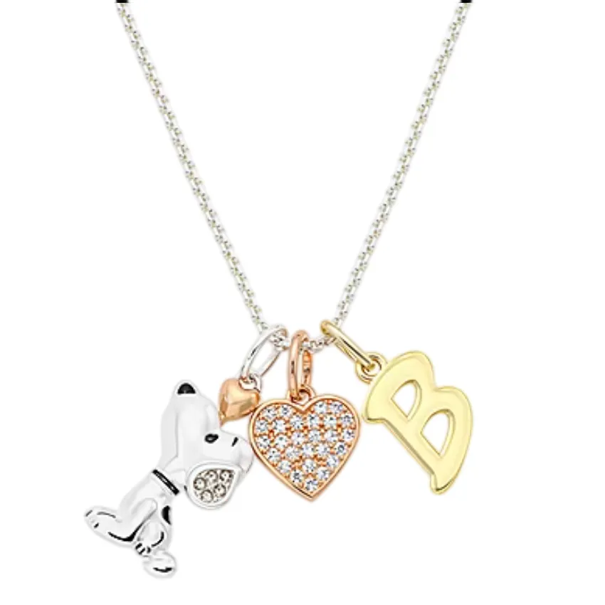 Necklace with four charms: a silver dog, a small gold heart, a crystal-studded heart, and a gold letter \“B\“.