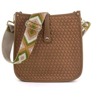 Brown woven crossbody bag with a geometric patterned strap featuring green, white, and mustard colors.