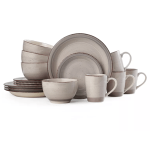 A stoneware dinnerware set with speckled beige finish includes dinner plates, salad plates, bowls, and mugs.