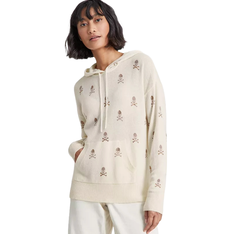 Ivory cashmere hoodie adorned with a subtle skull and crossbones pattern, featuring a front pocket, ribbed hem, and drawstring hood.