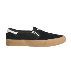 Black Adidas Slip-On Shmoofoil Shoes feature a canvas upper, gum rubber sole, and elastic side panels for easy wear, with a white Shmoofoil logo detail and a simple, casual design.