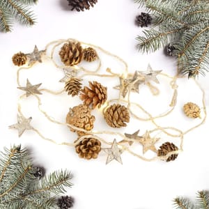 Set of 2 LED Christmas string lights featuring pinecones and silver stars on a twine cord, surrounded by green pine branches.