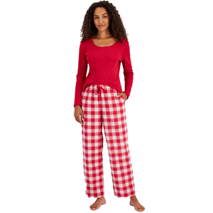 A woman wearing a red long-sleeve top and checkered red and white pajama pants.
