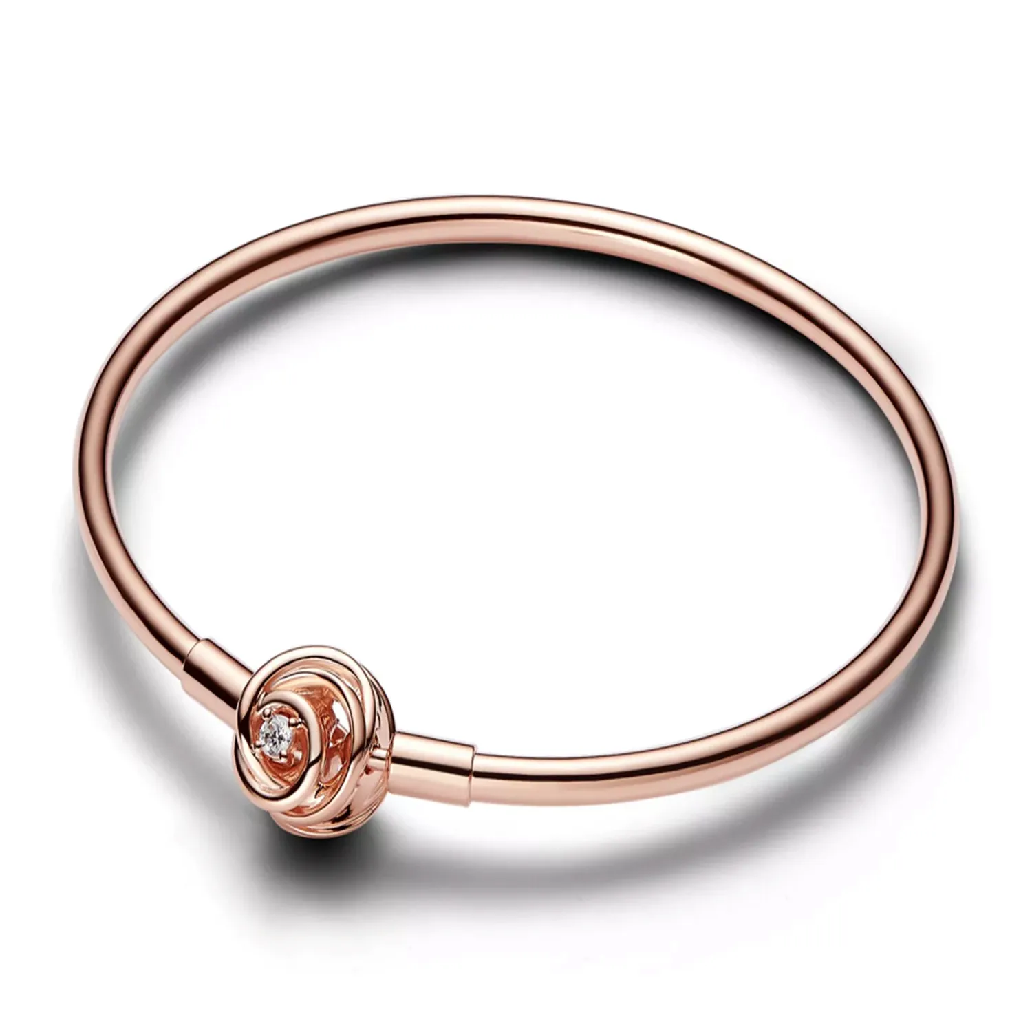 A rose gold bracelet featuring a central decorative knot with an embedded diamond-like stone, set on a sleek, closed-loop band.