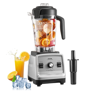 A blender with a transparent container filled with fruit and ice, alongside an orange juice glass, ice cubes, and oranges. Includes a black tamper.