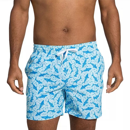 Blue swim trunks with a white drawstring and a shark pattern.