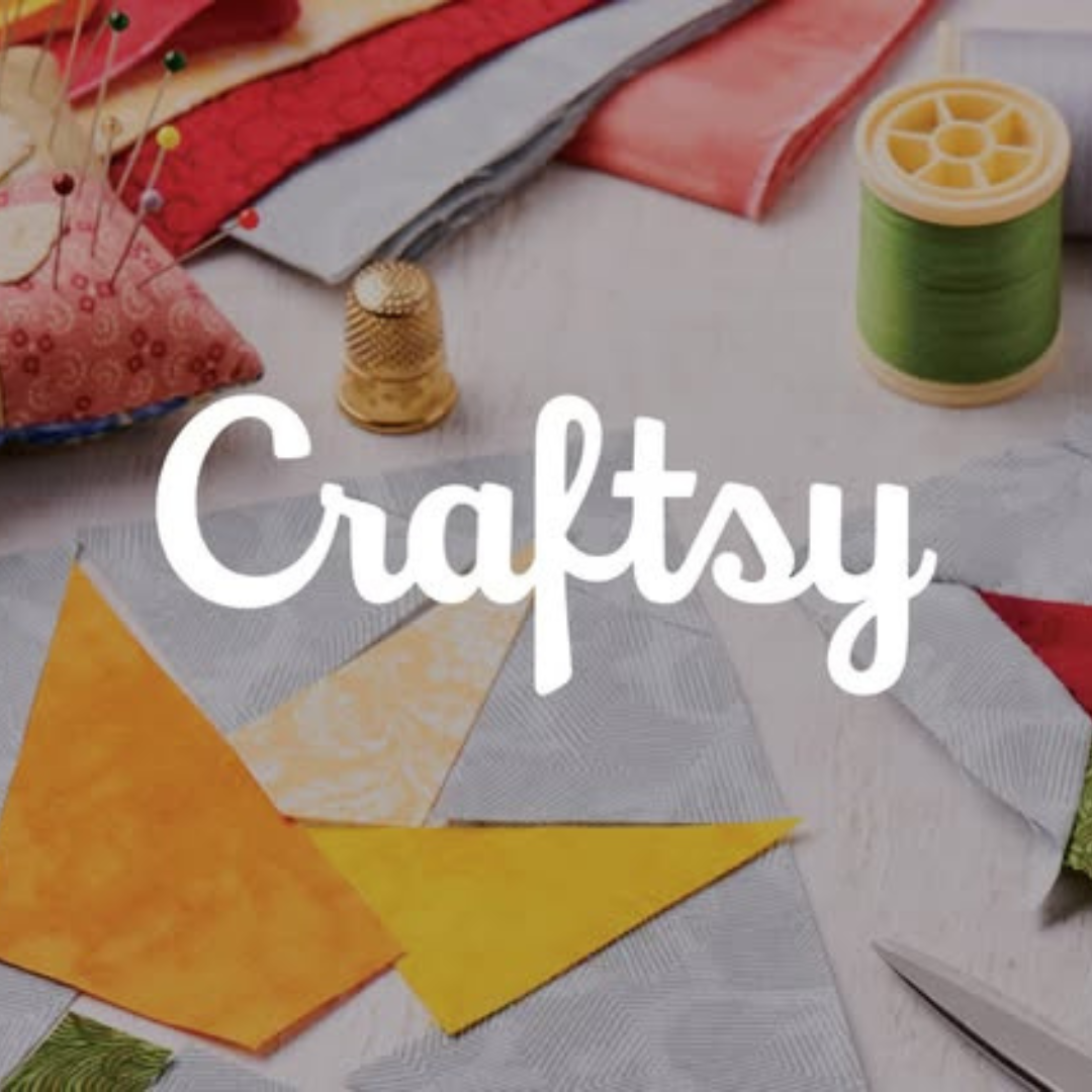 A crafting scene featuring colorful fabric squares, a spool of green thread, a thimble, push pins, and a pair of scissors, topped with the Craftsy logo.