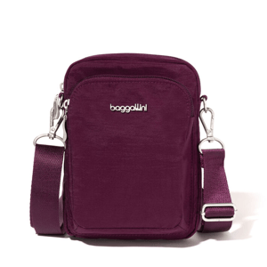 A small, plum-colored crossbody bag with \“baggallini\“ branding, featuring a detachable strap and a front zip pocket.