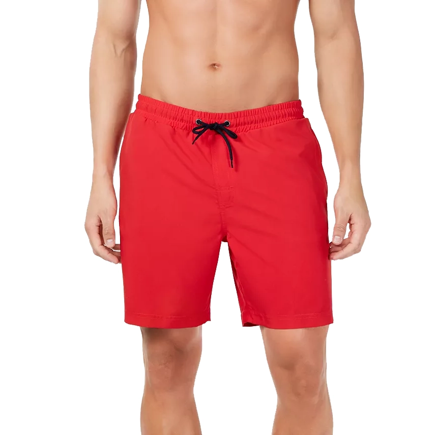 A person wearing plain red swim shorts with an adjustable black drawstring at the waist.