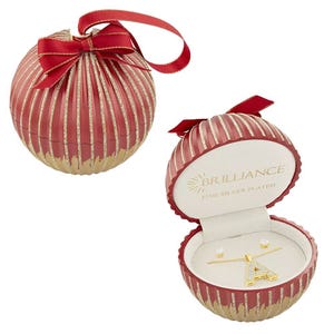 A red and gold striped ornament opens to reveal a fine silver-plated jewelry set by Brilliance, including a pair of stud earrings and a pendant with a letter \“A\“.
