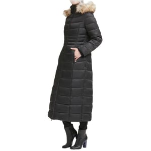 A long black puffer parka with a quilted design, featuring a fur-trimmed hood and side pockets, paired with black heeled boots.