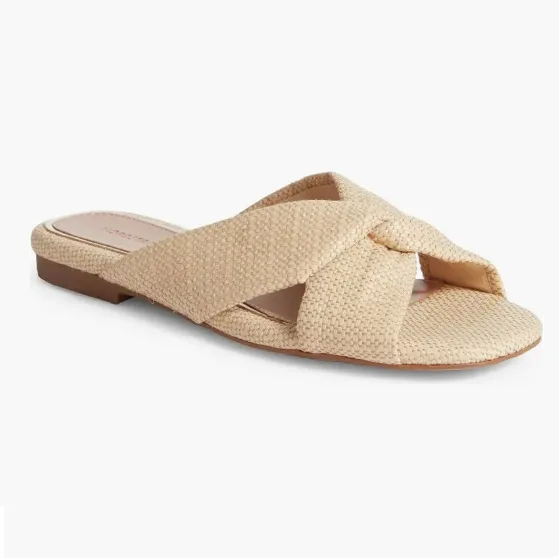 Beige textured slide sandal with crisscross straps.