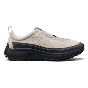 A beige sneaker with a textured upper, black sole, and blue accents. It features a rugged, traction-oriented outsole for outdoor activities.
