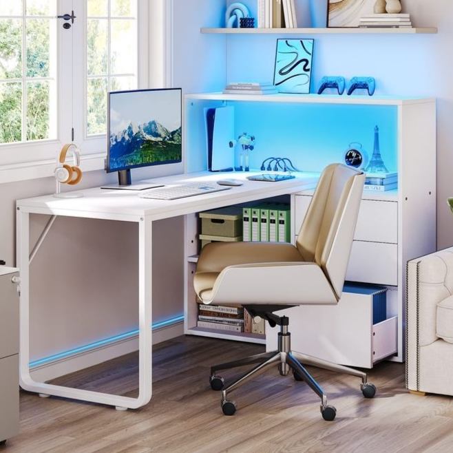 Modern home office setup with a white desk, computer monitor, tan office chair, and a shelving unit with blue LED lighting. Accessories include headphones, a printer, books, and decorative items like a mini Eiffel Tower and toy car.