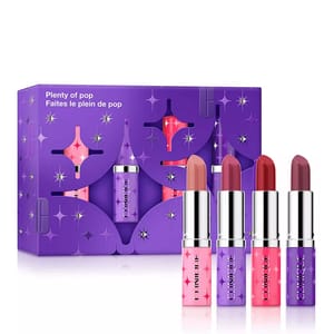 Four Clinique lipsticks are displayed in front of a purple box with star patterns. The packaging reads \“Plenty of pop.\“