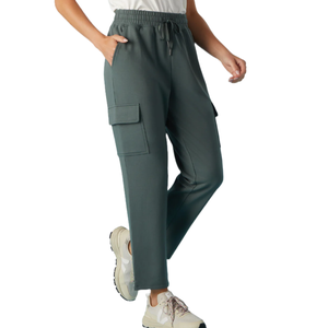Dark green cargo jogger pants with an elastic waistband and side pockets, paired with white sneakers.