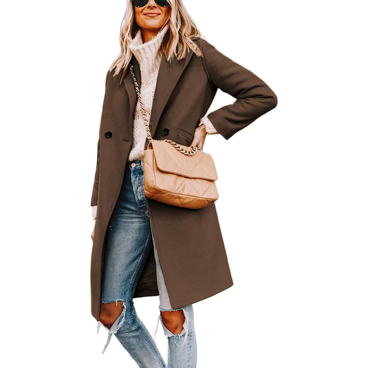 A woman is wearing a long brown coat, white turtleneck sweater, ripped jeans, and sunglasses, carrying a beige quilted handbag with a chain strap.