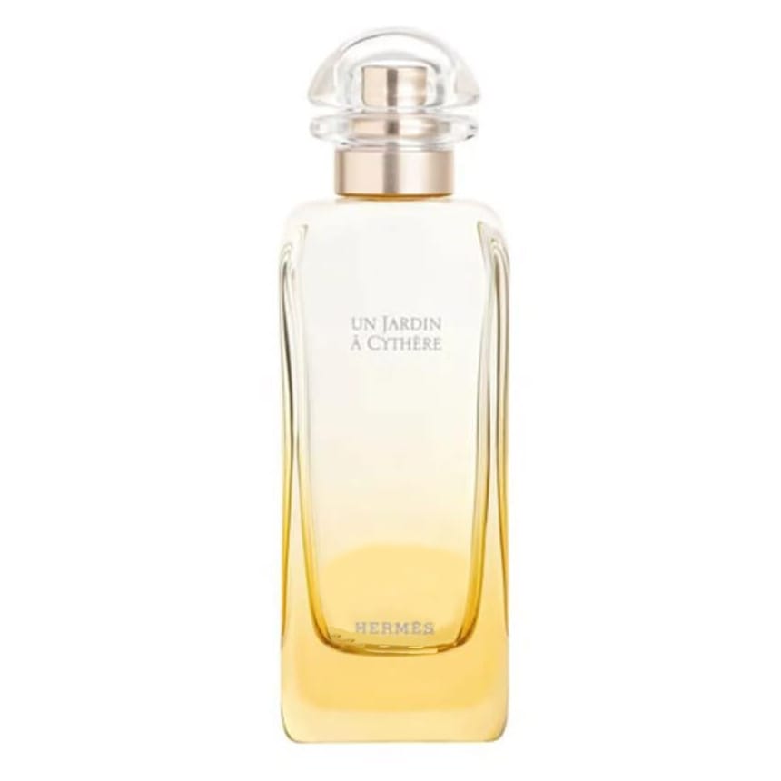 Hermes Men's Un Jardin A Cythere Spray features a sleek, transparent bottle with a gradient from clear to gold, topped with a round, clear cap. The label displays the name of the fragrance and the Hermes brand.