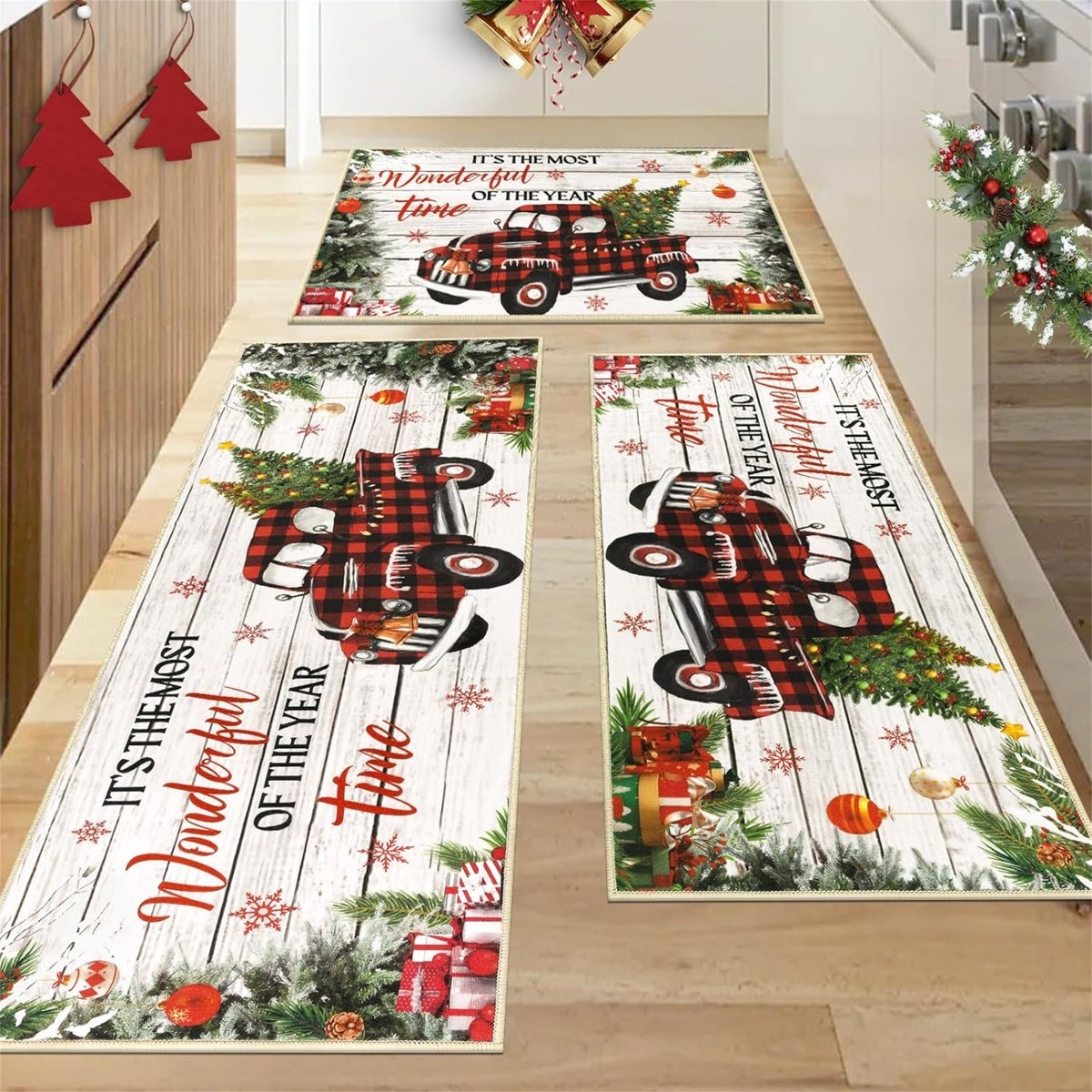 Festive kitchen rugs with a red plaid truck, Christmas trees, and gifts, featuring the phrase \“It's The Most Wonderful Time of the Year.\“