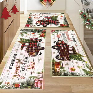 Festive kitchen rugs with a red plaid truck, Christmas trees, and gifts, featuring the phrase \“It's The Most Wonderful Time of the Year.\“