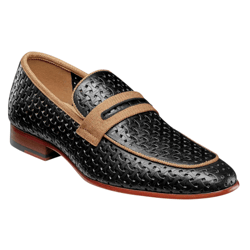 A black leather loafer with a textured woven design, trimmed in light brown, featuring a matching strap across the top and a wooden heel.