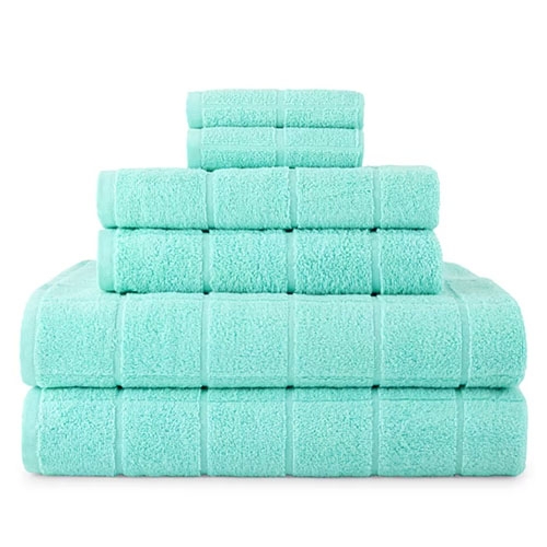 A set of mint-green towels stacked in three sizes: two large bath towels at the bottom, followed by three hand towels in the middle, and topped with two washcloths.