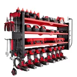 Wall-mounted tool storage system with shelves holding drills, batteries, and cases in black and red, alongside organized hand tools like screwdrivers and wrenches.