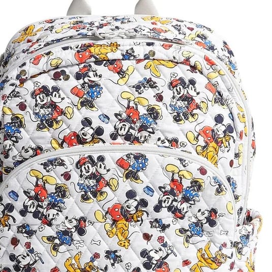 A backpack featuring a vibrant pattern with classic cartoon characters like Mickey Mouse and Minnie Mouse, wearing colorful outfits.