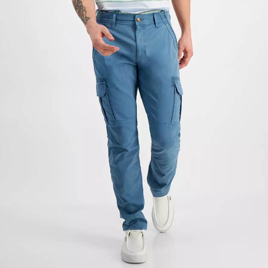 Blue cargo pants with side pockets, worn with white sneakers.