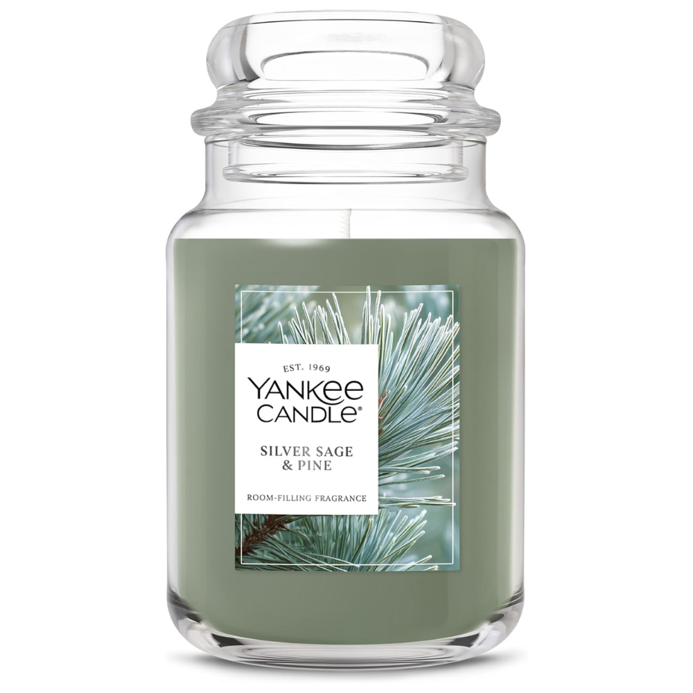 Yankee Candle with \“Silver Sage & Pine\“ scent in a large glass jar with a green wax.