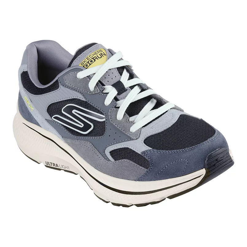 Skechers Go Run Consistent Shoes are athletic shoes featuring a gray and navy color scheme with white laces. They have an ULTRA LIGHT cushioned sole for comfort and support, and a distinctive \“S\“ logo on the side.