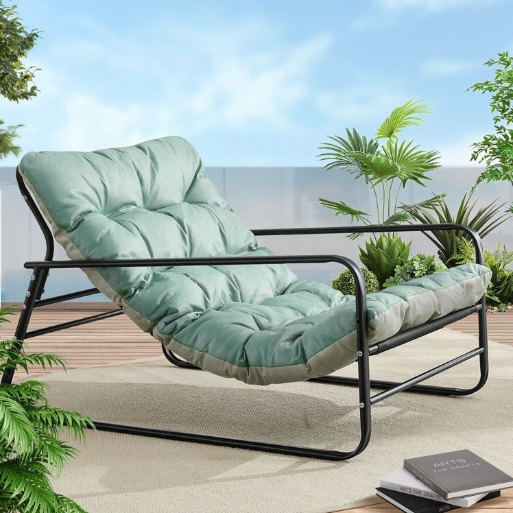 A comfortable outdoor lounge chair with a metal frame and cushioned seat, surrounded by potted plants on a wooden deck.