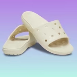 A pair of white slide-on sandals with ventilation holes is displayed against a gradient purple and blue background.