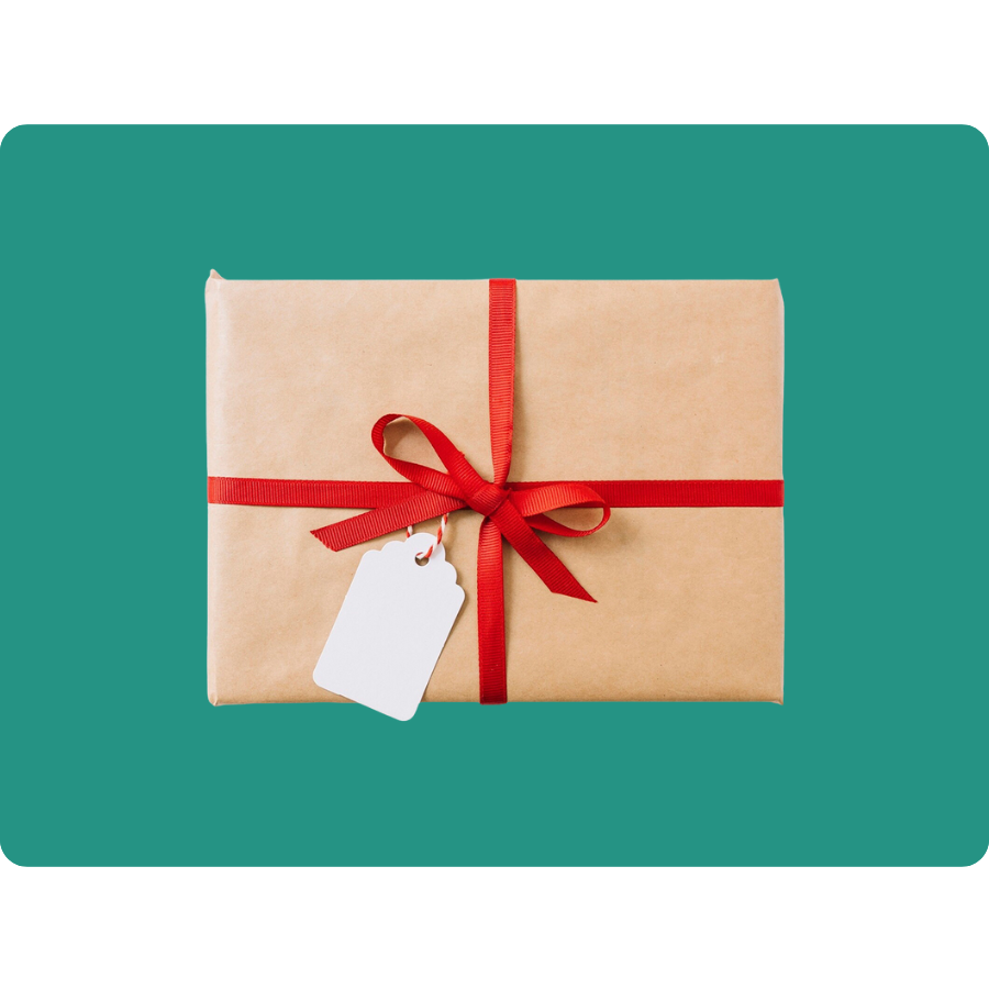 A neatly wrapped gift with brown paper and a red ribbon, featuring a blank white gift tag, set against a teal background.