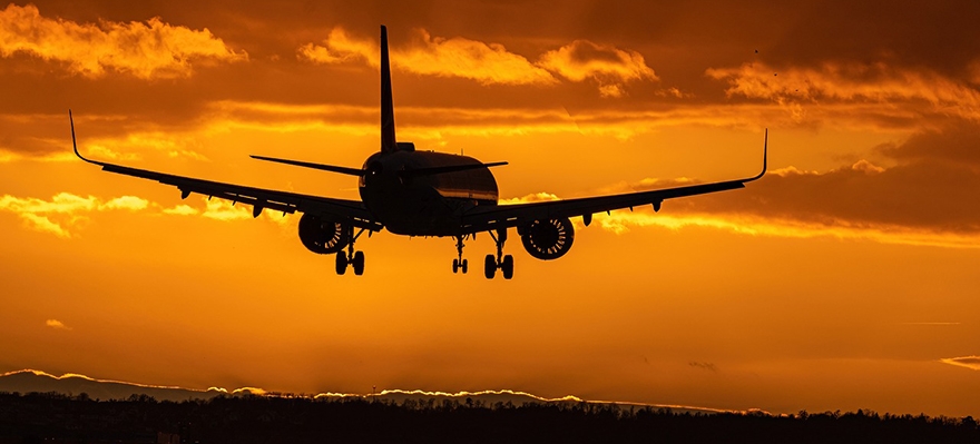 airplane flying in sunset