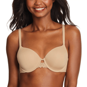 A woman is wearing a nude-colored bra with thin straps and a subtle lace detail at the center. She's smiling with her hair down.