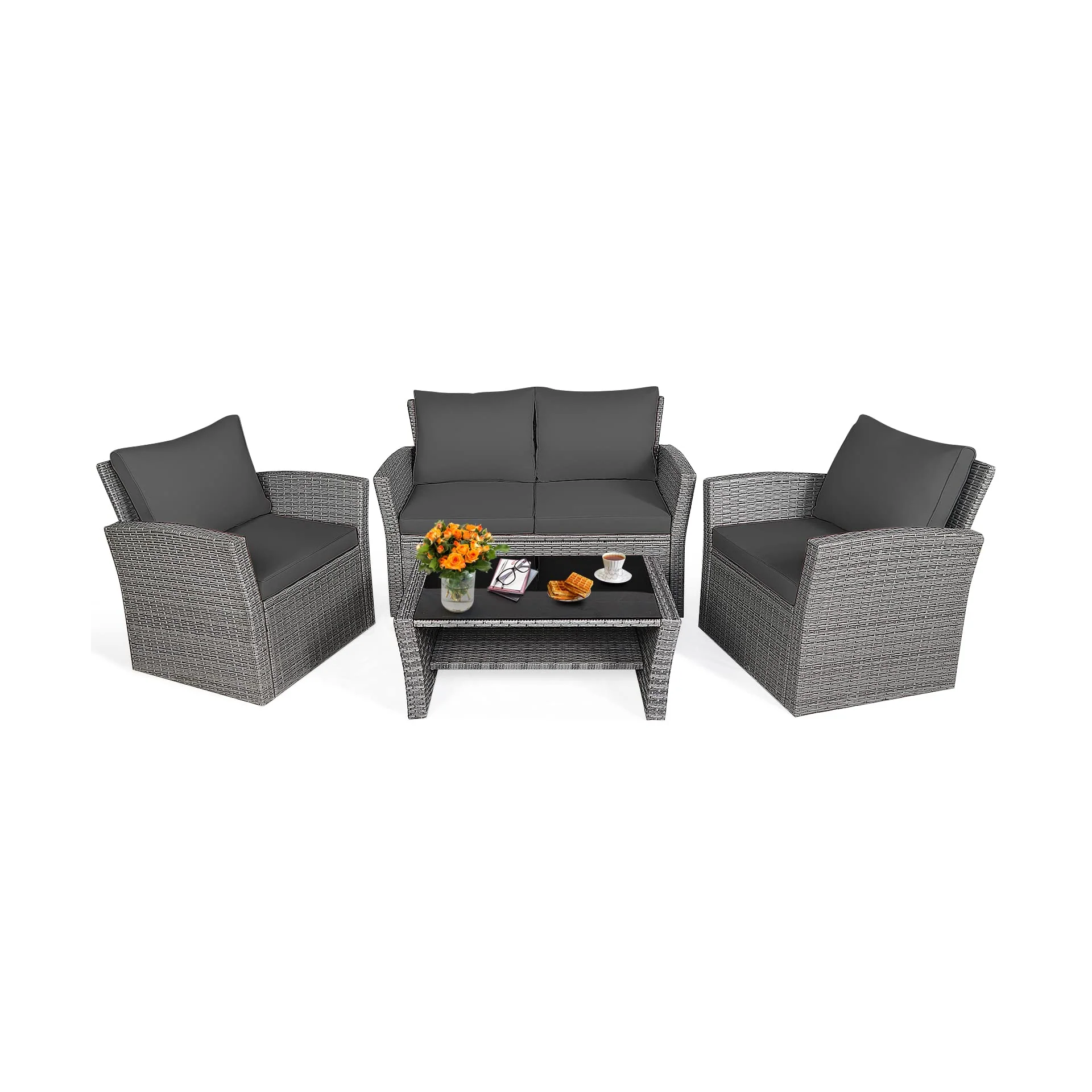 Outdoor patio furniture set with gray wicker and cushions includes a loveseat, two armchairs, and a coffee table with decorations like flowers, books, and snacks.