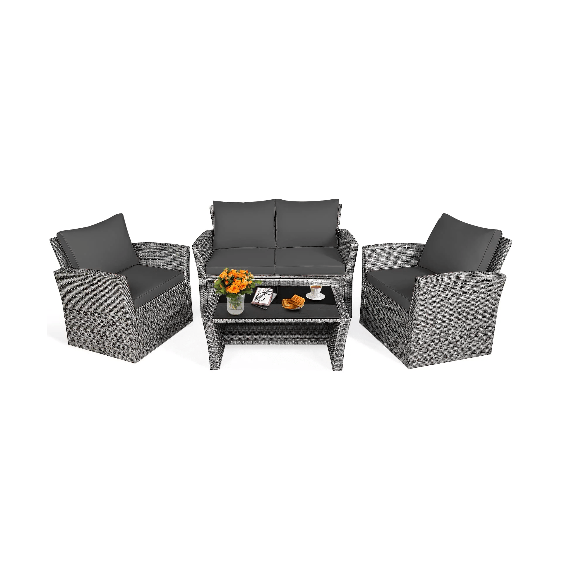 Outdoor patio furniture set with gray wicker and cushions includes a loveseat, two armchairs, and a coffee table with decorations like flowers, books, and snacks.