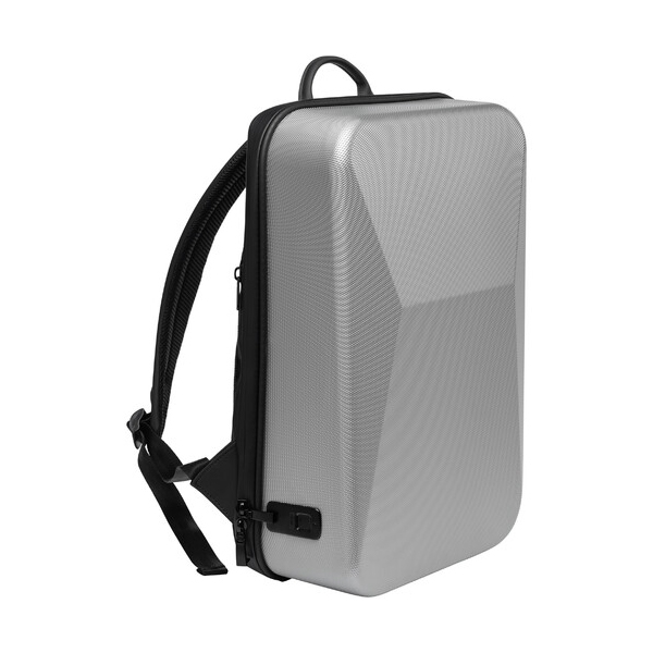 A sleek, hard-shell silver backpack with black straps and a handle, featuring a minimalist design and a lock mechanism on the side.