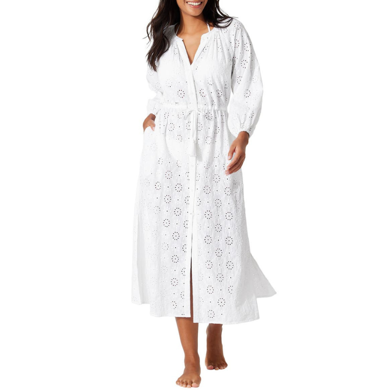White embroidered cover-up dress with eyelet detailing, featuring long sleeves, a tie waist, and a front slit.