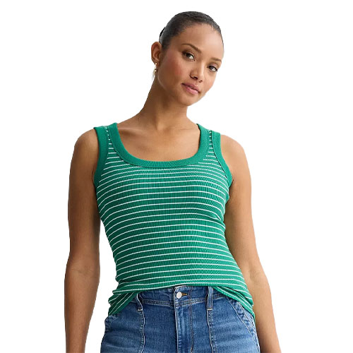 A woman is wearing a green and white striped tank top paired with blue jeans.