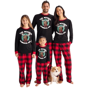 A family of four and a dog are wearing matching holiday-themed pajama sets featuring black tops with \“The Moosed Wonderful Time\“ and red-black checkered pants.