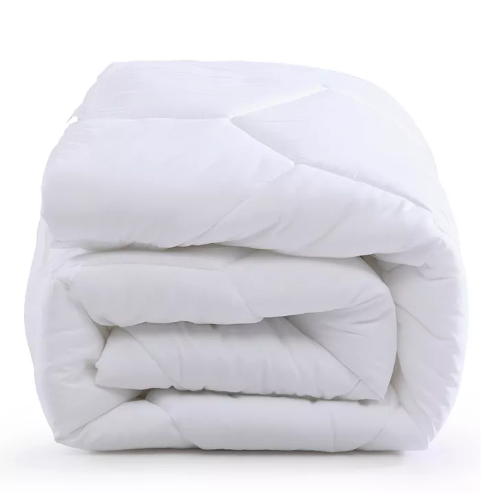 A neatly folded white mattress pad with a quilted design, suggesting a plush and comfortable texture.