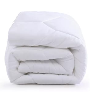 A neatly folded white mattress pad with a quilted design, suggesting a plush and comfortable texture.