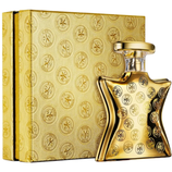A gold-toned perfume bottle and matching box both feature the \“Bond No. 9\“ NYC circular logo pattern.