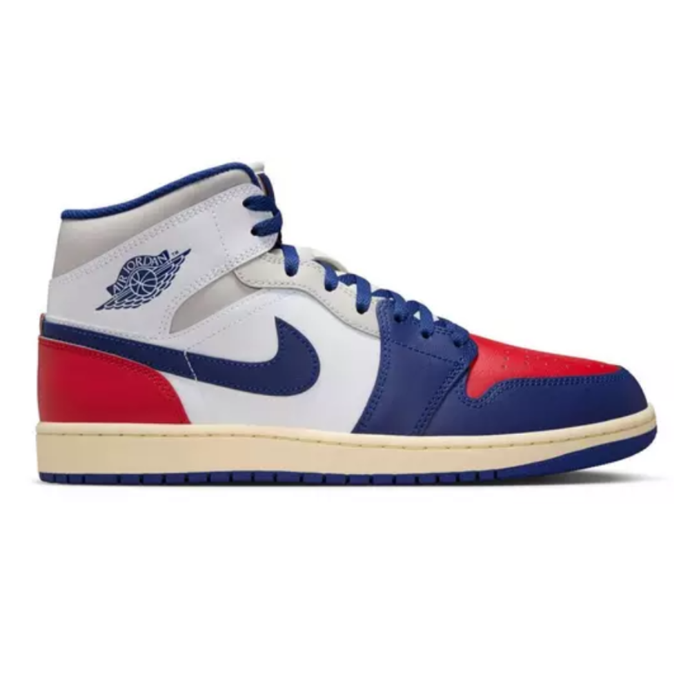 A multicolor Nike Air Jordan sneaker featuring red, white, and blue hues with the iconic Nike swoosh and Air Jordan wings logo.