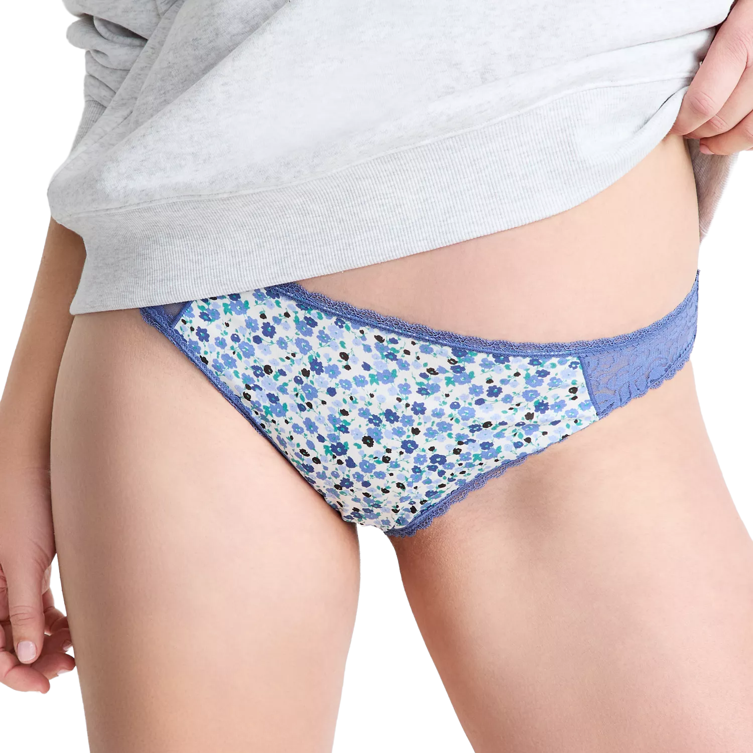 Blue floral lace-trimmed panties worn by a person, partially covered by a light gray top.