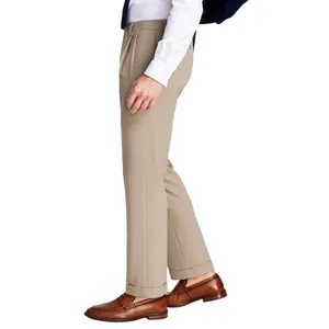 A person is wearing beige dress pants and brown loafers, paired with a white shirt.
